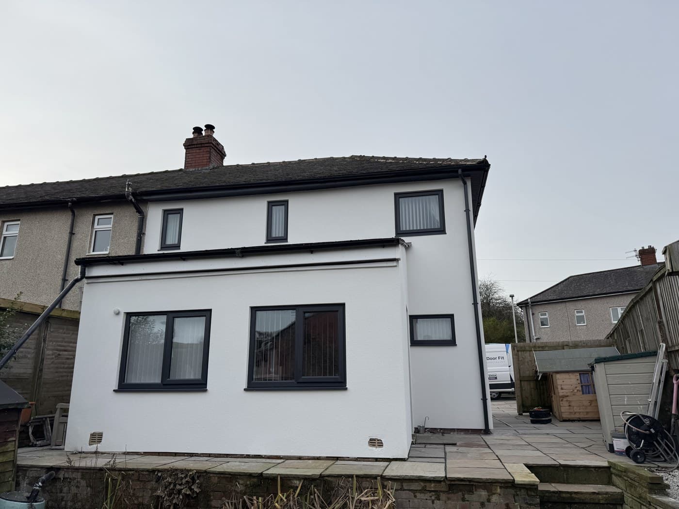 The rear of a white rendered semi with new anthracite uPVC windows