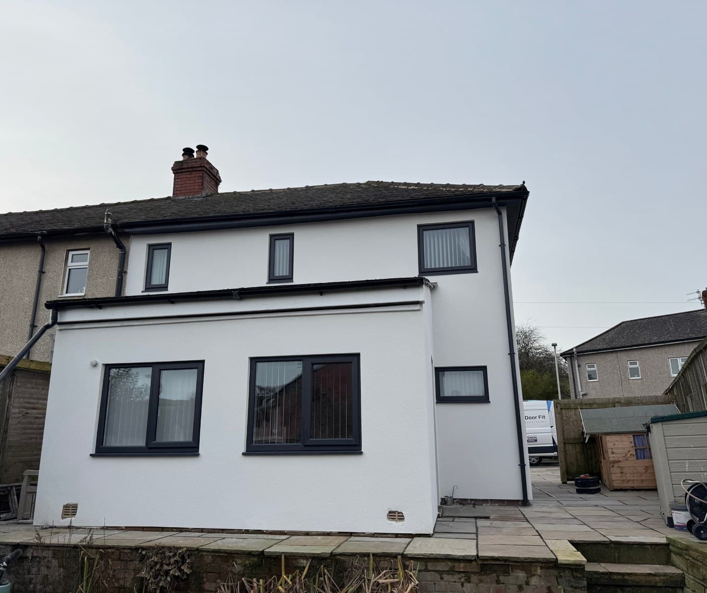 A white rendered house with anthracite uPVC windows